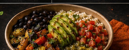A vegetarian bowl with rice, black beans, charred vegetables, avocado and pico in a kraft bowl.
