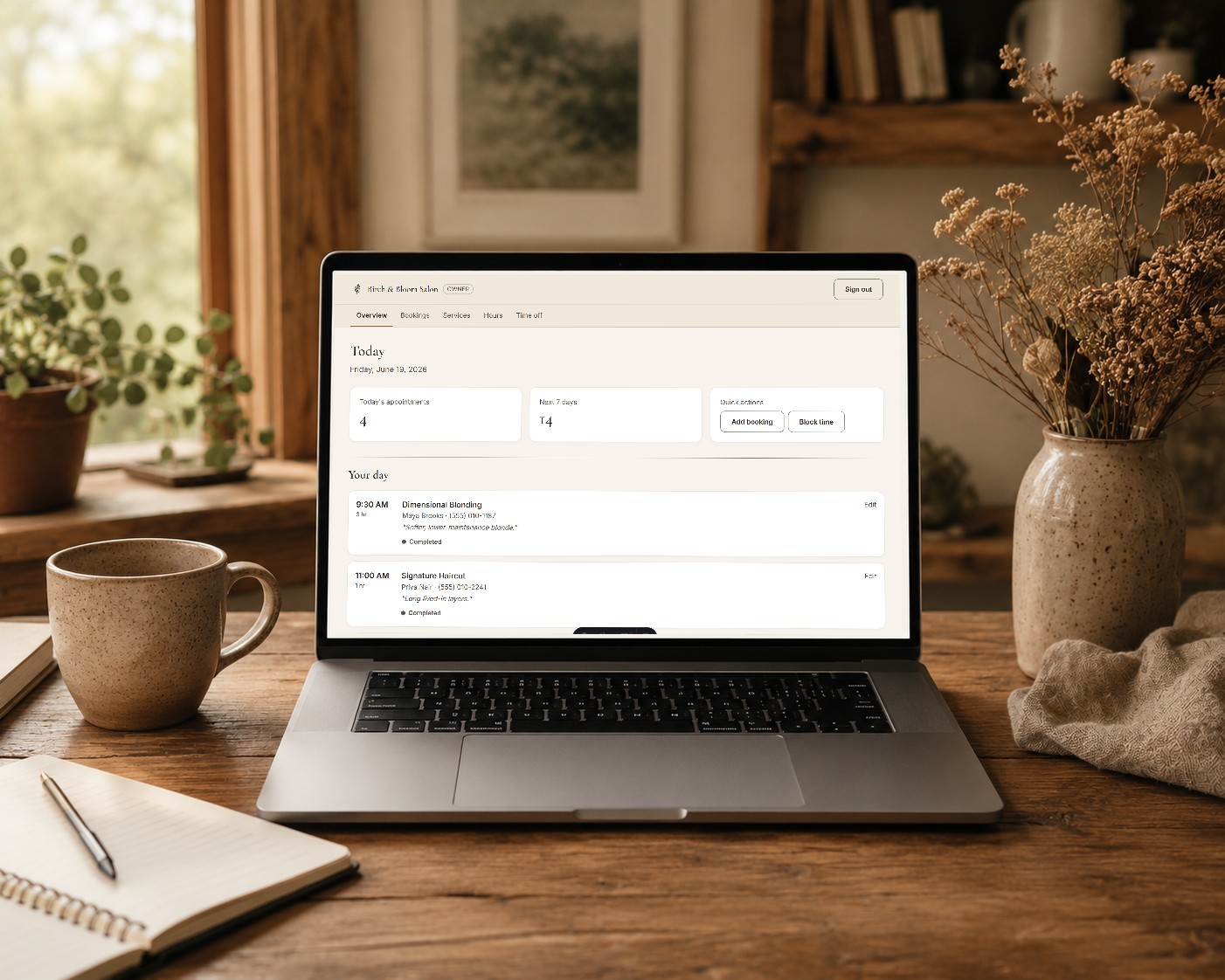 A laptop on a desk showing the Birch and Bloom owner booking dashboard with the day's appointments.