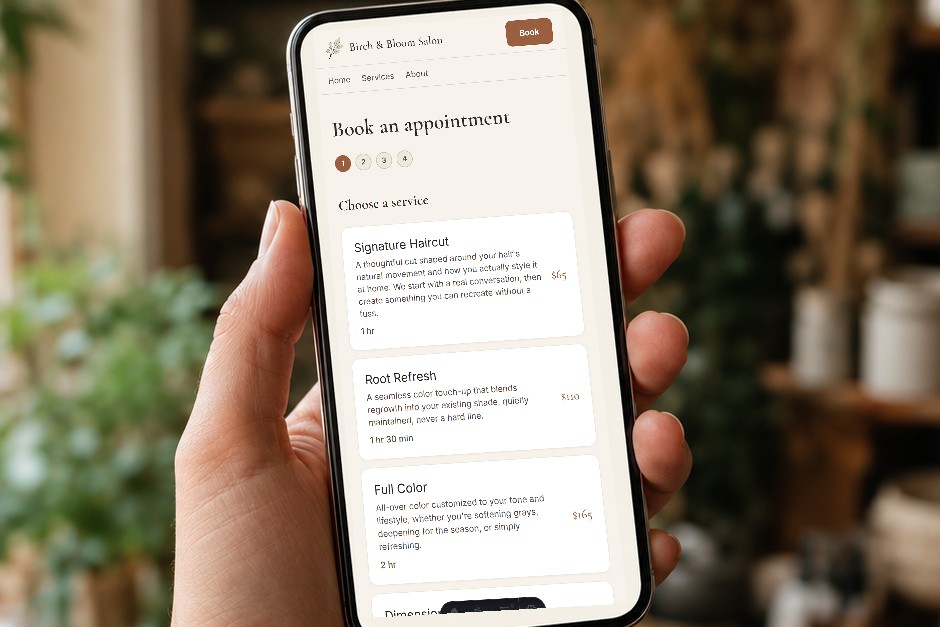 A phone in hand showing the Birch and Bloom booking screen.